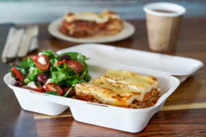 Lasagne and salad in clamshell packaging