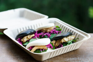 Chicken and salad on bao buns in clamshell container